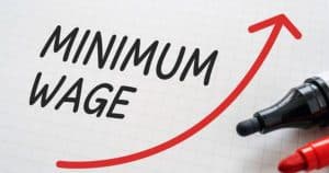 minimum wage with arrow and pens
